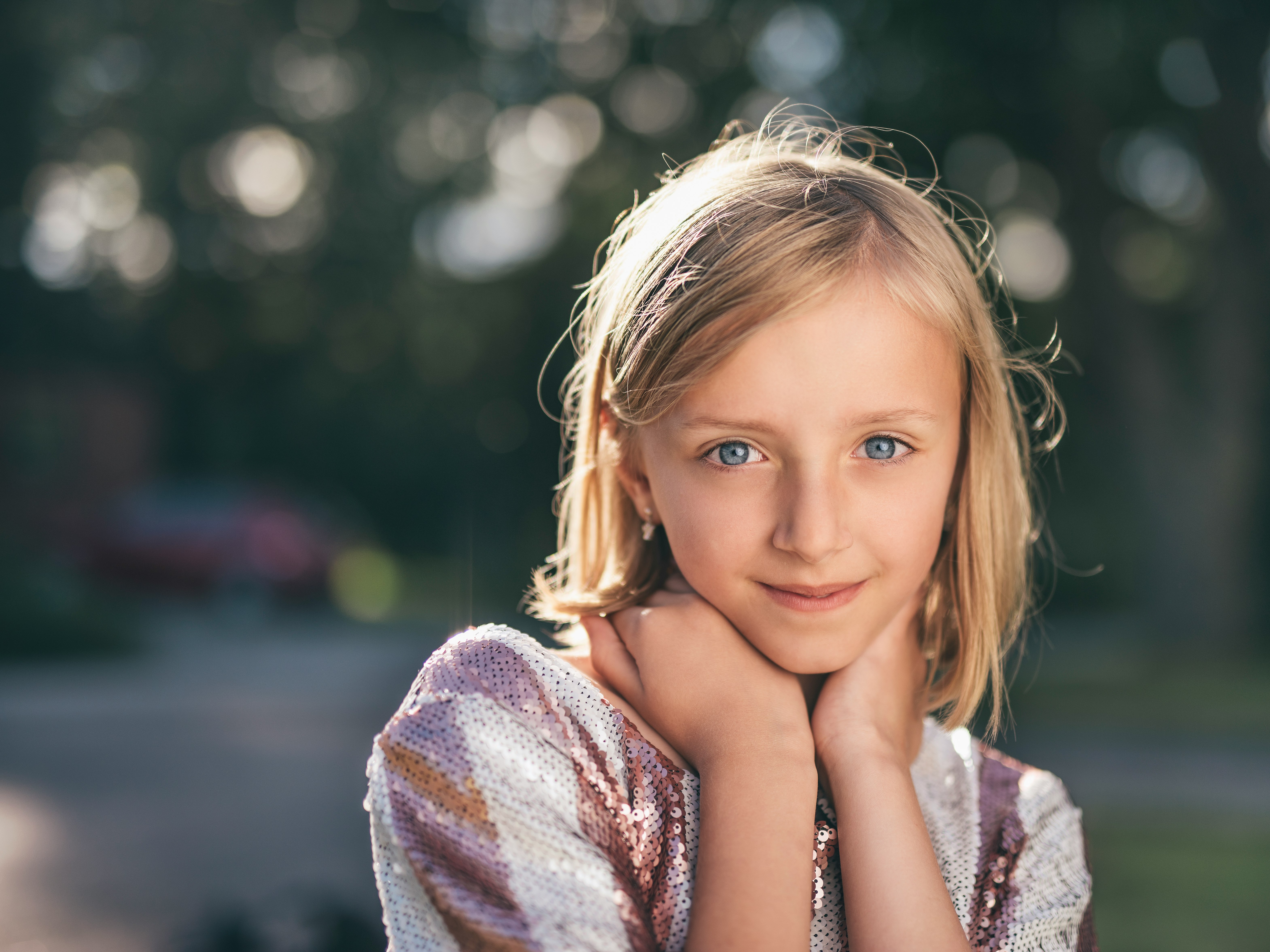 selective focus photography of girl in sequined white-and-pink stripe shirt